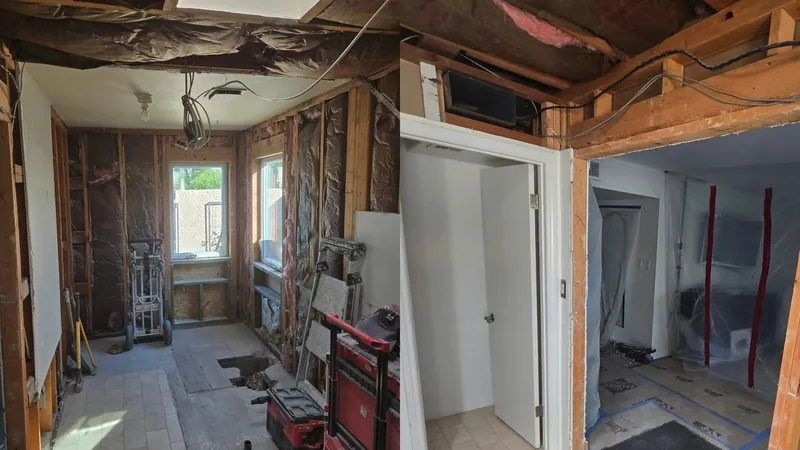 Room stripped to bare studs with floor protection and equipment in the corner after demolition